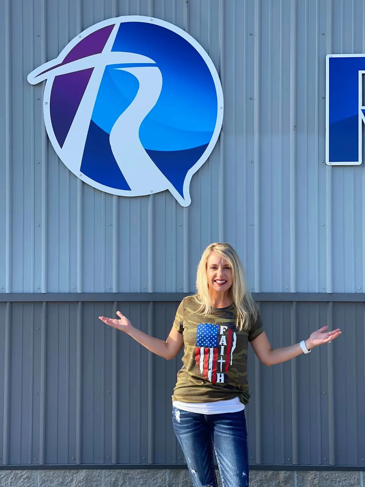 A member of The River Church welcoming visitors outside the building
